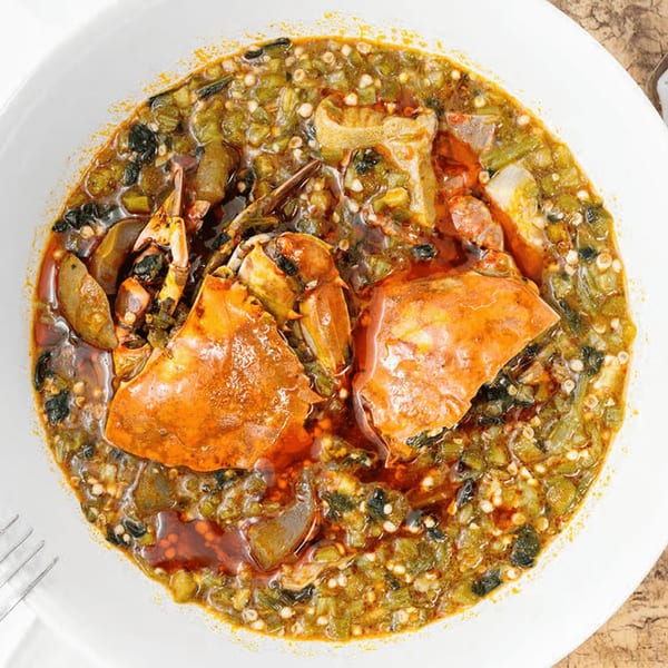 African Okra soup with crab and other seafood in a white bowl, from Safari77 Cuisine.